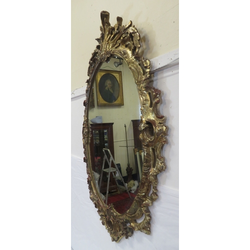 174 - Regency design carved timber gilded oval mirror with ornate scroll & foliate decoration 115 x70cm