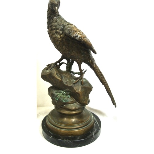 228 - Ornate bronzed figure of a falcon on a rock, on round stepped base