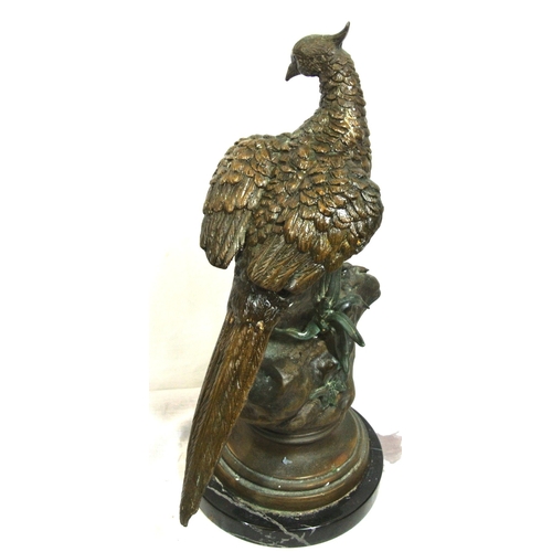 228 - Ornate bronzed figure of a falcon on a rock, on round stepped base