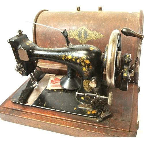 53 - Gilt decorated Singer sewing machine in oak case