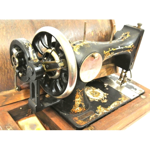 54 - Decorated Vickers sewing machine in oak case