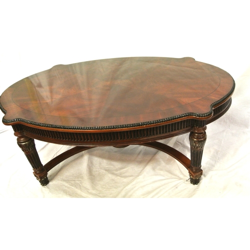 60 - French style oval coffee or occasional table with serpentine borders, reeded frieze and legs with sh... 