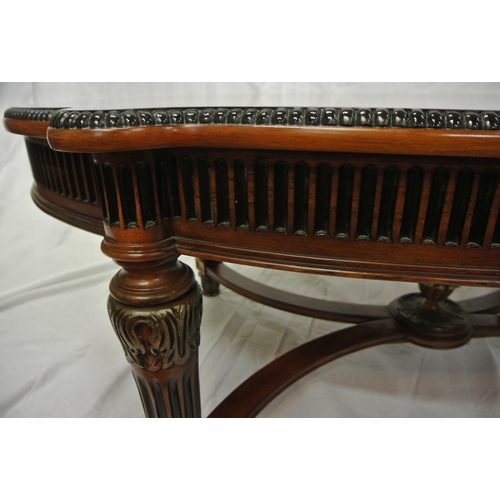 60 - French style oval coffee or occasional table with serpentine borders, reeded frieze and legs with sh... 