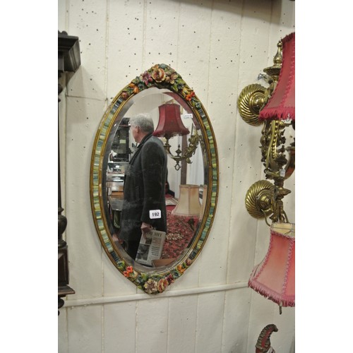 192 - Ornate Dresden style oval bevelled glass wall mirror with ornate foliate decorated porcelain frame