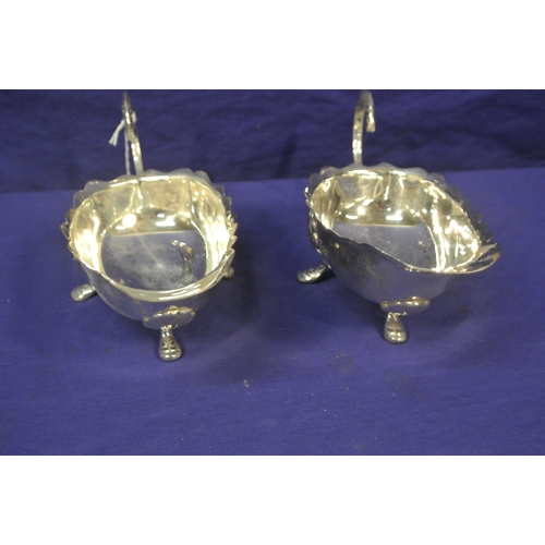 36 - Pair of silver plated sauceboats with wavy rims, scroll handles, on hoof feet