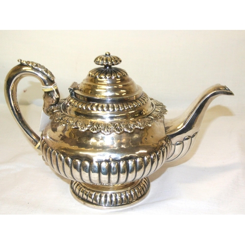 106 - Irish silver teapot of round form with reeded finial and lid, acanthus leaf rim, reeded lower body, ... 