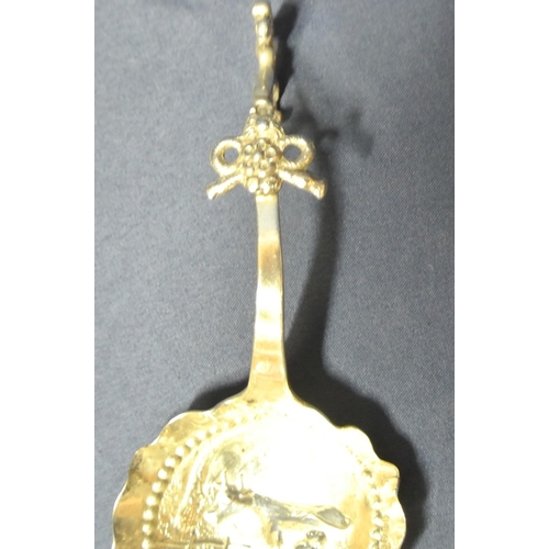 32 - Continental silverplated conserve spoon with ornate embossed cow milking scene and shaped hook handl... 