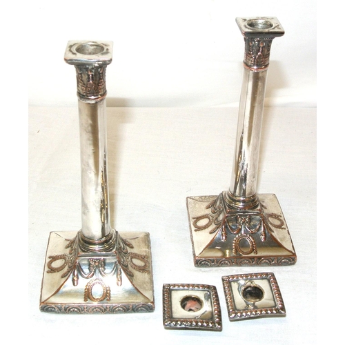 38 - Pair of silver plated small candlesticks of round tapering form, with ribbon and oval decoration and... 