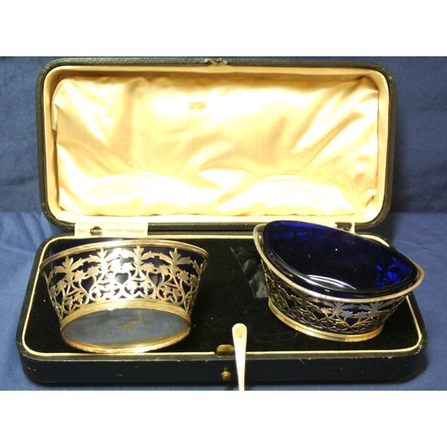 48 - Pair of London silver oval salts with pierced angular sides, reeded rims and blue glass liners, in p... 