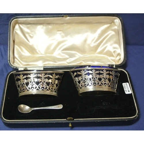 48 - Pair of London silver oval salts with pierced angular sides, reeded rims and blue glass liners, in p... 