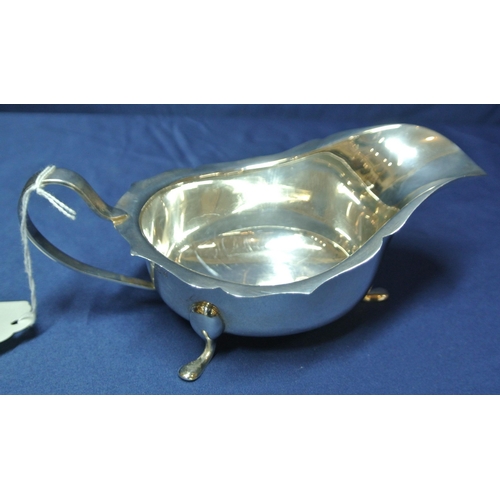 77 - Birmingham silver sauceboat with wavy rim, shaped handle and pad feet, 168g, 18cm