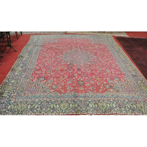 337 - Large red ground Persian Kashan carpet with traditional lozenge medallion design. 345x250cm