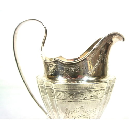 149 - Irish silver helmet shaped cream jug of oval tapering form with concave corners, shaped handle, with... 