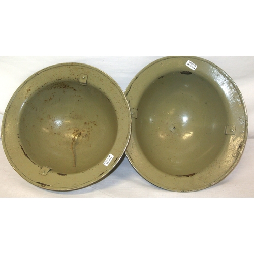 256 - A pair of Irish Army Brodie helmets, light green, paint scuffs and spots, missing liner