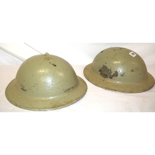 256 - A pair of Irish Army Brodie helmets, light green, paint scuffs and spots, missing liner