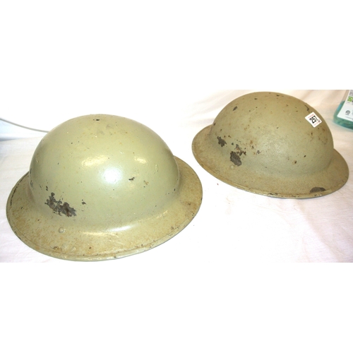 257 - Pair of Irish Army Brodie helmets, light green, paint scuffs and spots, no liner