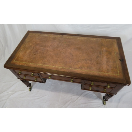 345 - Edwardian walnut & mahogany desk with leatherette inset, 5 drawers with brass handles, on turned ree... 