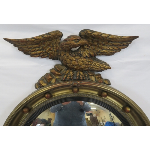 398 - Regency style convex mirror with eagle surmount & ball decoration