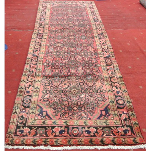 272 - Washed red ground full pile Iranian village runner. 310 x102cm