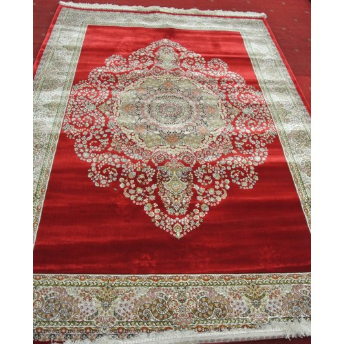 312 - Full pile fine woven red ground bamboo silk carpet with traditional floral design. 230 x 160 cm