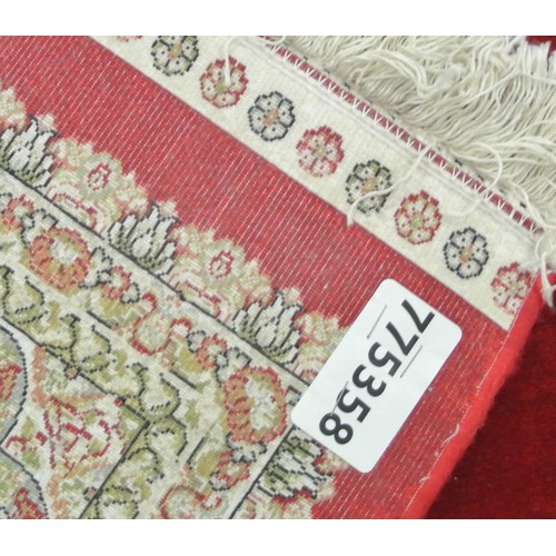 312 - Full pile fine woven red ground bamboo silk carpet with traditional floral design. 230 x 160 cm