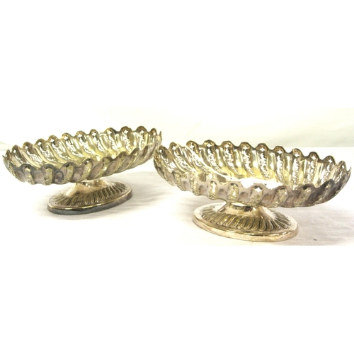 14 - Pair of oval silver plated bread or sweet dishes with pierced reeded sides, wavy rims, on oval sprea... 