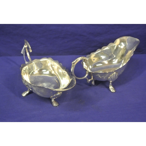 36 - Pair of silver plated sauceboats with wavy rims, scroll handles, on hoof feet