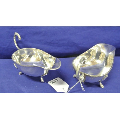 84 - Pair of boat shaped silver plated sauceboats with Celtic design rims, S-scroll handles and hoof feet