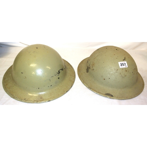 257 - Pair of Irish Army Brodie helmets, light green, paint scuffs and spots, no liner