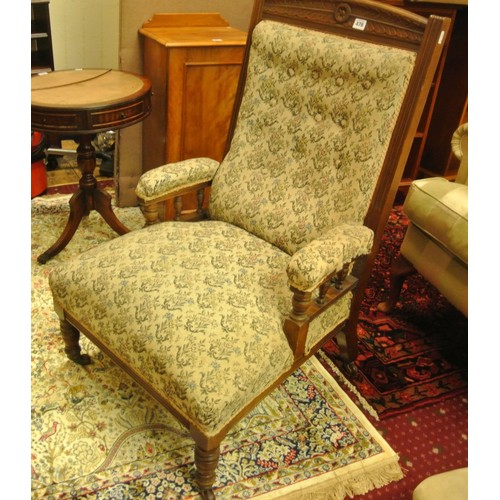 476 - Victorian armchair with foliate upholstery, on turned tapering legs with casters