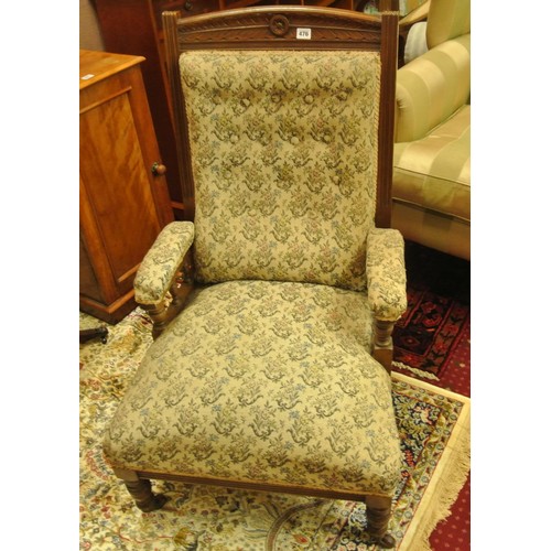 476 - Victorian armchair with foliate upholstery, on turned tapering legs with casters