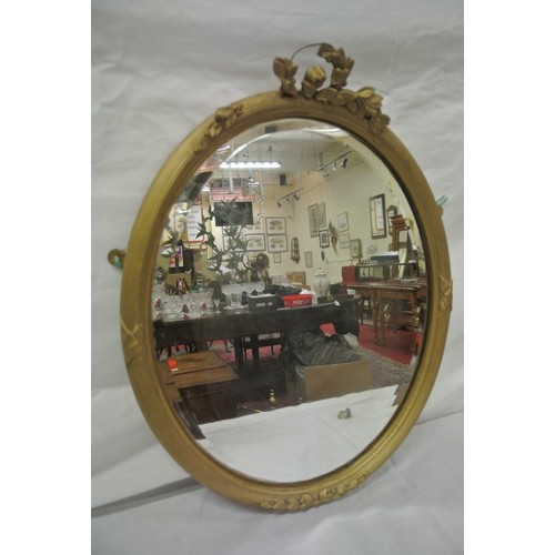 386 - Oval gilt framed bevelled glass mirror