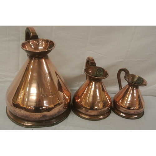 382 - Set of three Georgian style copper measures with shaped handles