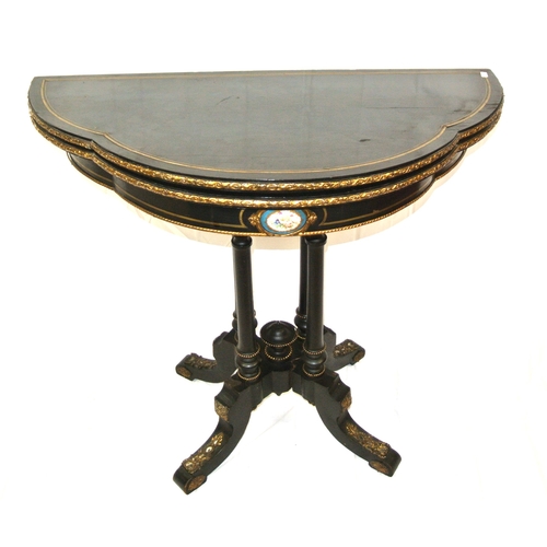 215 - Louis XV style inlaid ebonised card table of serpentine demi-lune form, with brass inlay, ormolu bor... 