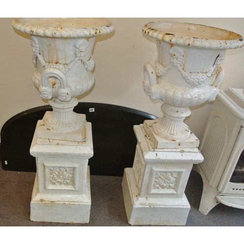 207 - Pair of Victorian style cast iron campana shaped garden vases with grape vine & reeded decoration, o... 