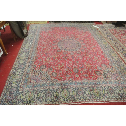 217 - Large red ground Persian Kashan carpet with traditional lozenge medallion design. 345x250cm