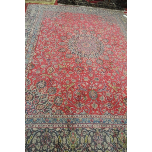 217 - Large red ground Persian Kashan carpet with traditional lozenge medallion design. 345x250cm