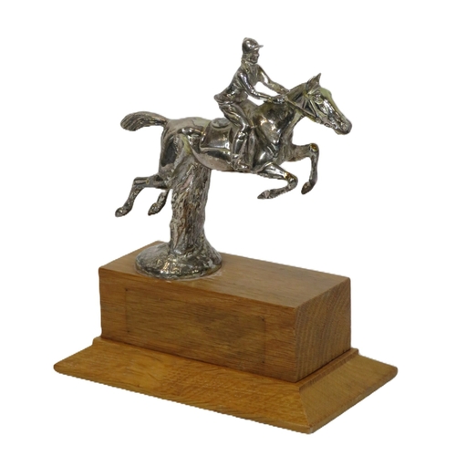 226 - Chrome ornament of a rider & show jumper on raised timber base