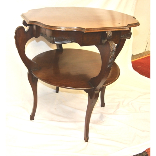 134 - Edwardian mahogany two tier occasional table with shaped borders, foliate decorated columns, on spla... 