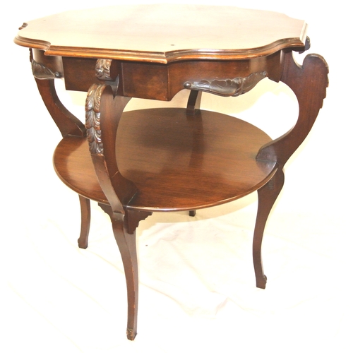 134 - Edwardian mahogany two tier occasional table with shaped borders, foliate decorated columns, on spla... 