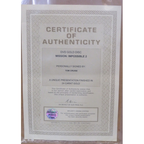 64 - Tom Cruise 'Mission Impossible II' DVD gold disc collection, framed with certificate from Our Price ... 