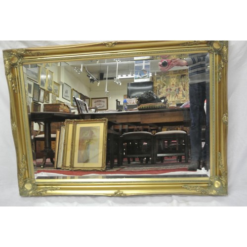 122 - Regency design oblong bevelled wall mirror with ornate foliate decoration 106 x76cm