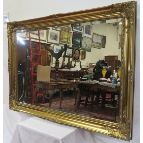 147 - Ornate Regency design gilt framed bevelled glass wall mirror with foliate decoration 105cm x 75 cm