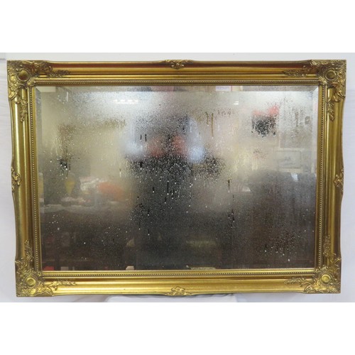 147 - Ornate Regency design gilt framed bevelled glass wall mirror with foliate decoration 105cm x 75 cm