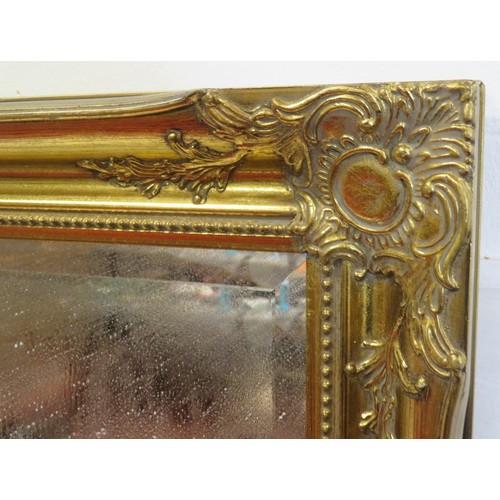 147 - Ornate Regency design gilt framed bevelled glass wall mirror with foliate decoration 105cm x 75 cm