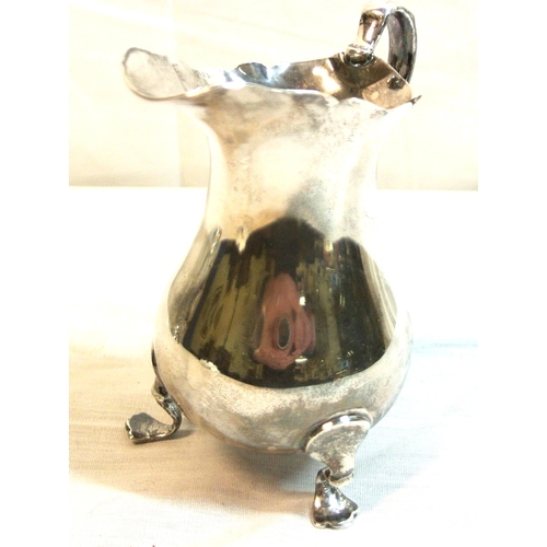94 - London silver creamer of baluster form with wavy rim and handle, on 3 cast feet, 10cm, 111g