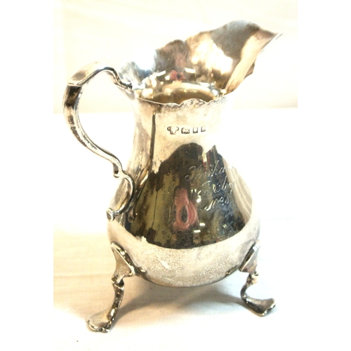 94 - London silver creamer of baluster form with wavy rim and handle, on 3 cast feet, 10cm, 111g