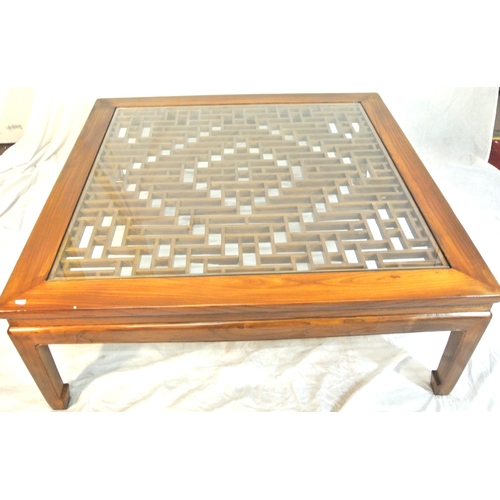100 - Large square mahogany coffee or centre table with Chippendale style fretwork and glass top