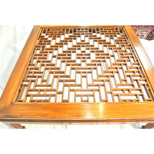 100 - Large square mahogany coffee or centre table with Chippendale style fretwork and glass top