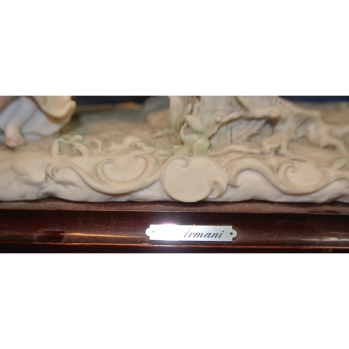 128 - Ornate Capodimonte group 'See-saw', with ornate foliate decoration